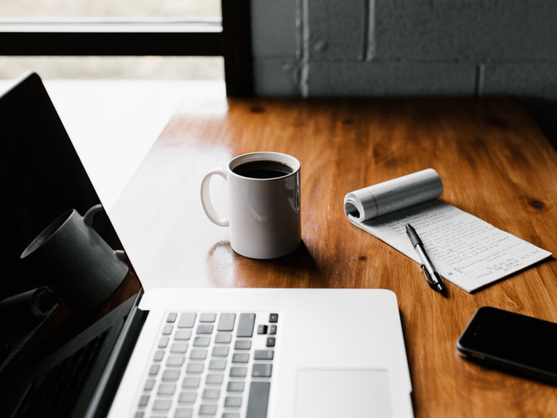 Drafting A Wedding Guest List - Coffee, Pad, Pen, And Laptop